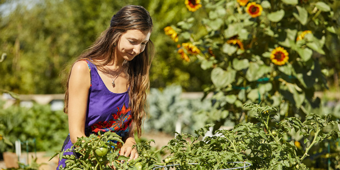woman gardening at centerra master-planned community in loveland, co