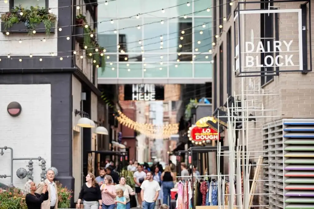 Crowded urban alley with string lights, 