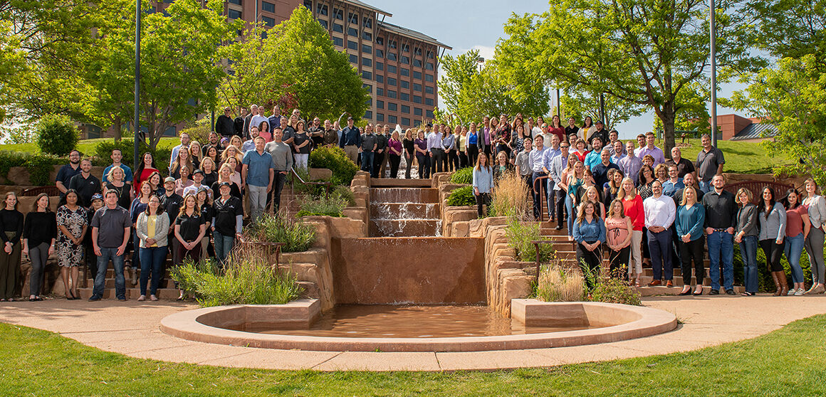 mcwhinney employees gathered around a fountain