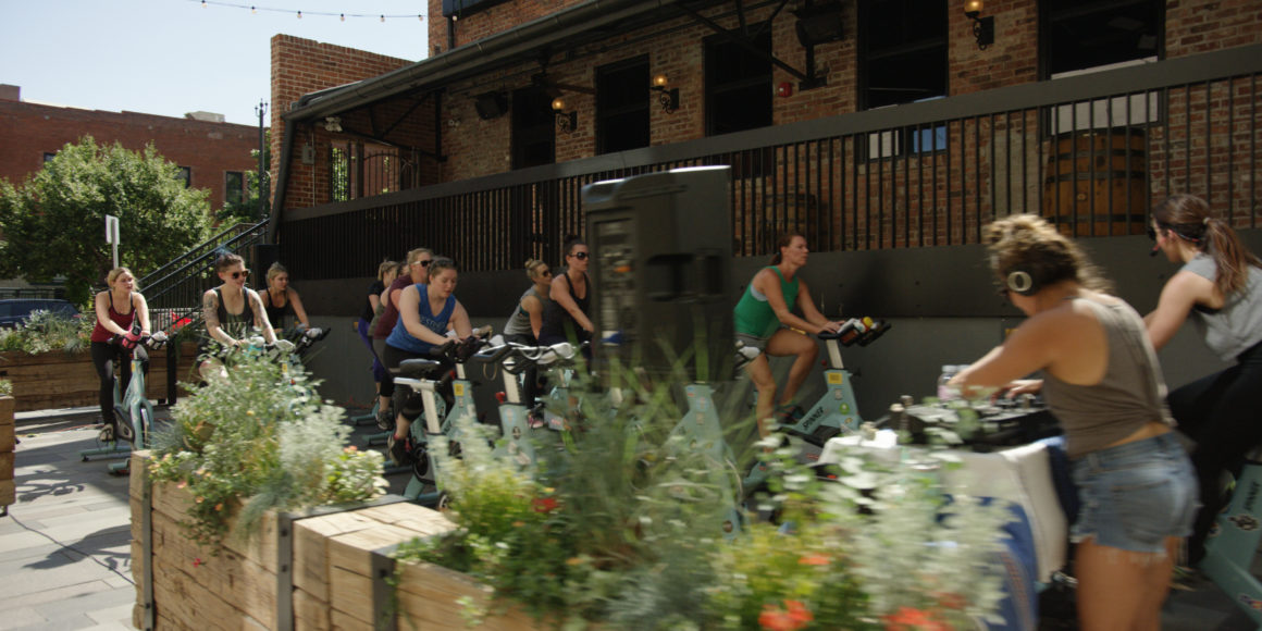people taking a spinning class at a mcwhinney property